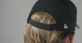 Man modeling Glides Black Classic Cap.